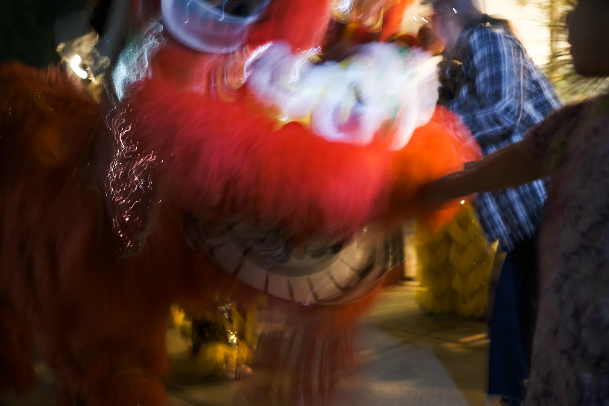 Red lion dance costume blurred in motion at a Lunar New Year celebration