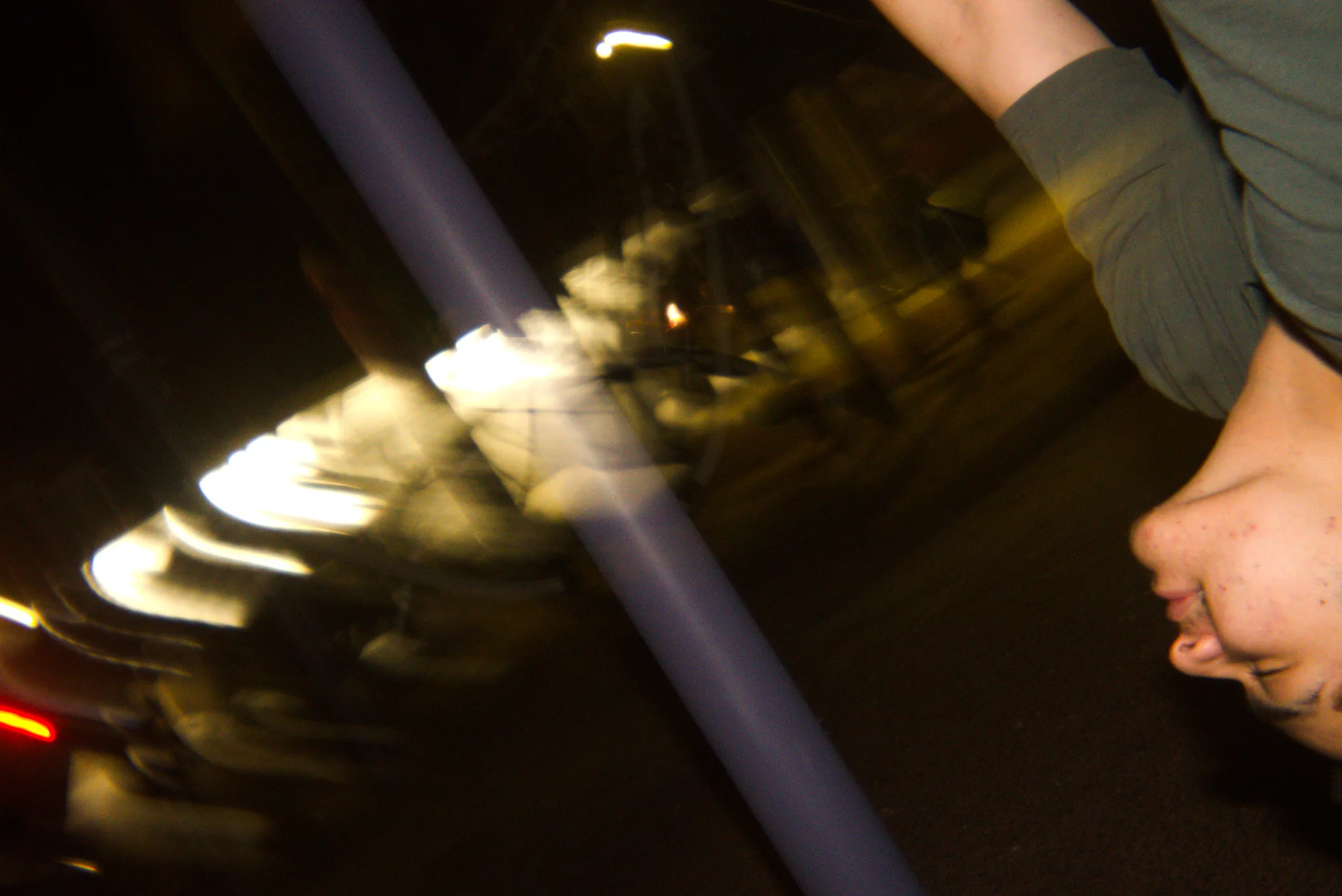 Motion-blurred street lights at night photographed from a moving car