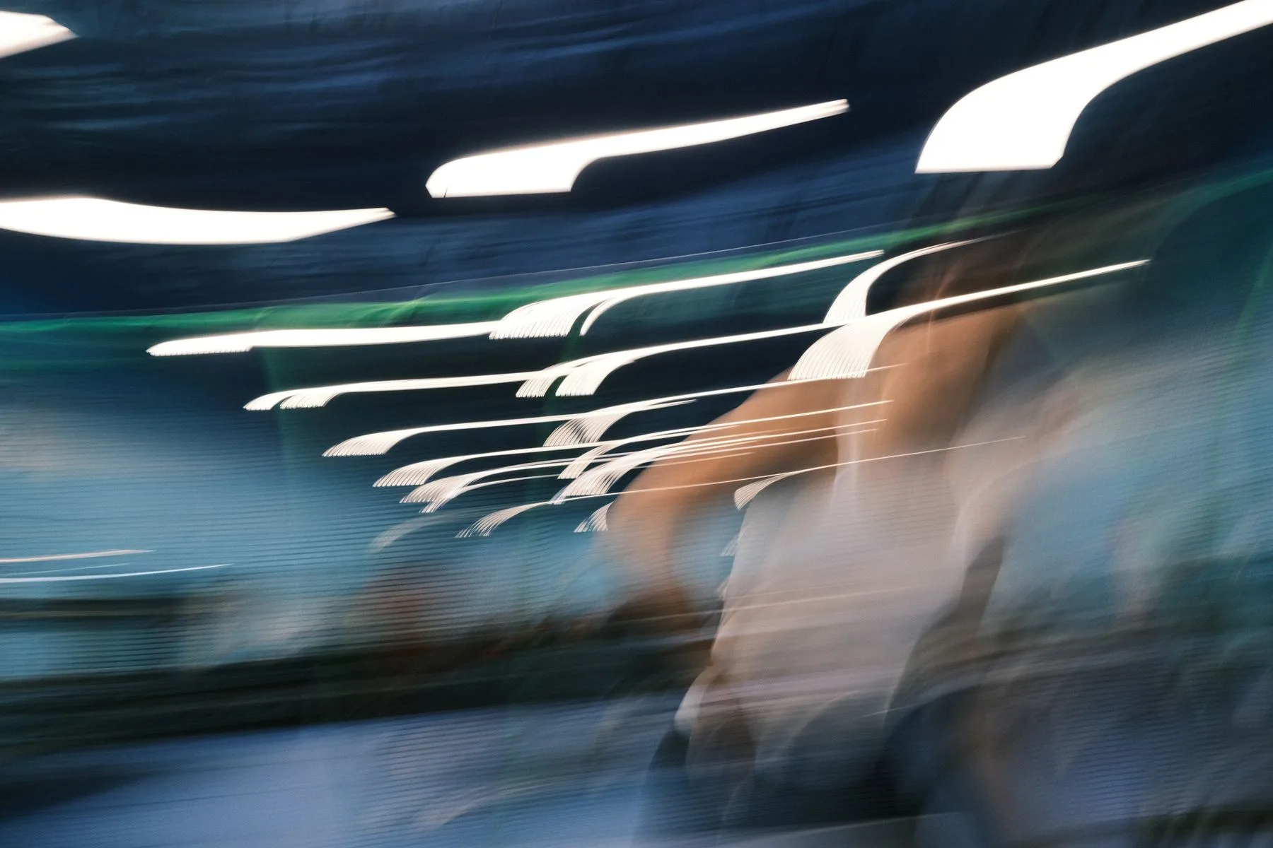 Motion-blurred rows of white hangers in a clothing store